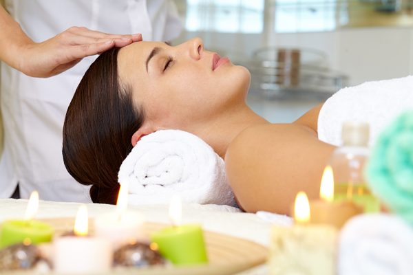 Woman getting a facial massage in a spa