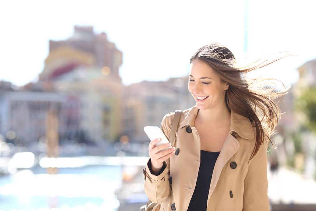 Woman using her phone to book appointments online